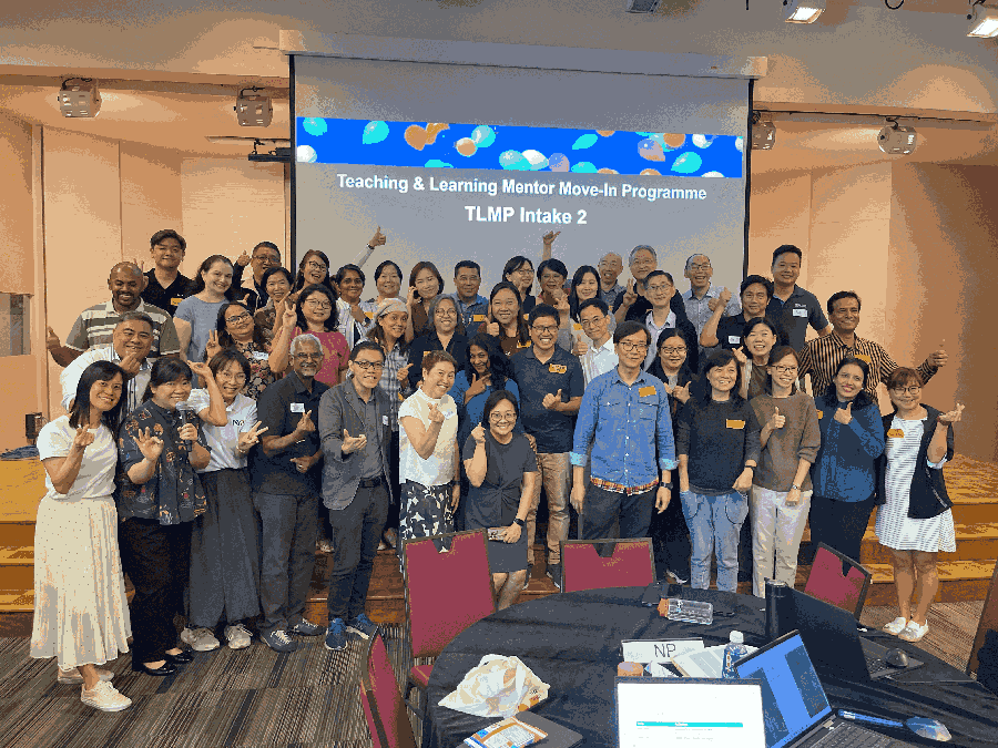  Gemini said Large group photo of TLMP In2 participants posing in front of a presentation screen.