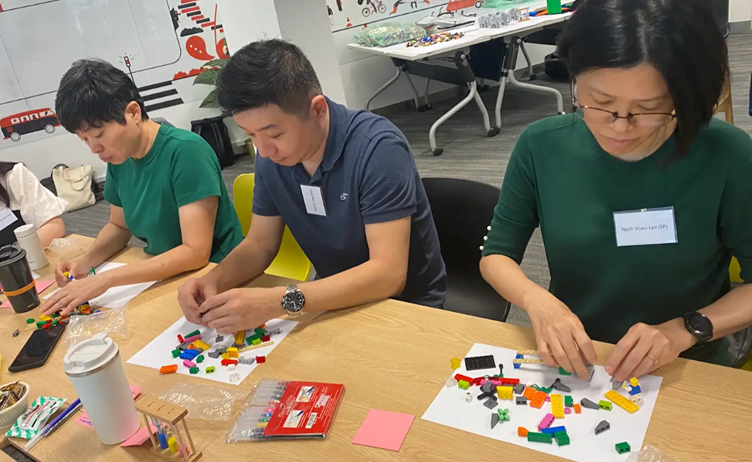 3 people building blocks